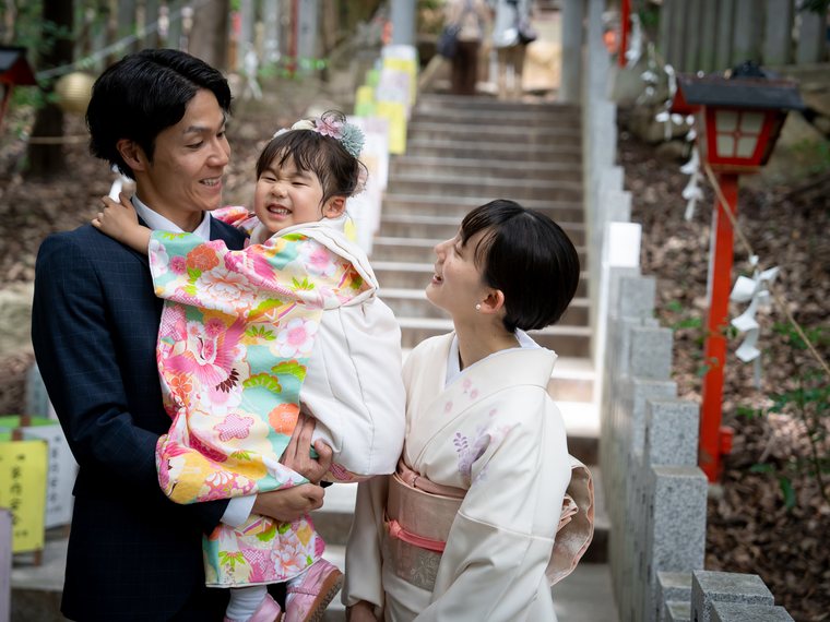 抱き上げられて笑う七五三のお子様